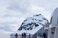 Zaandam passengers brave the cold and high winds to view the mountains as we enter the Lemaire Channel Photo from Susan's Story, Zaandam passengers brave the cold and high winds to view the mountains as we enter the Lemaire Channel