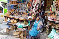 A colorful Aymara woman selling her goods in the witches market in La Paz Photo from Susan's Story, A colorful Aymara woman selling her goods in the witches market in La Paz