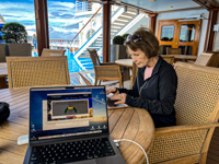 Susan at work typing her travel story outside on deck 14 Photo from Susan's Story, Susan at work typing her travel story outside on deck 14