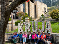 The women on our tour posing under the Kruja sign Photo from Susan's Story, The women on our tour posing under the Kruja sign