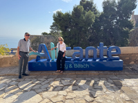 Hugh and Susan standing in front of the sign in Alicante, Spain Susan's Story, Hugh and Susan standing in front of the sign in Alicante, Spain