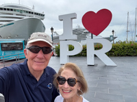 Susan and Hugh in front of the I love PR sign Susan's Story, Susan and Hugh in front of the I love PR sign