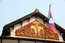 the Laotian flag and their royal symbol Photo from Susan's Story, a rooftop the Laotian flag and their royal symbol